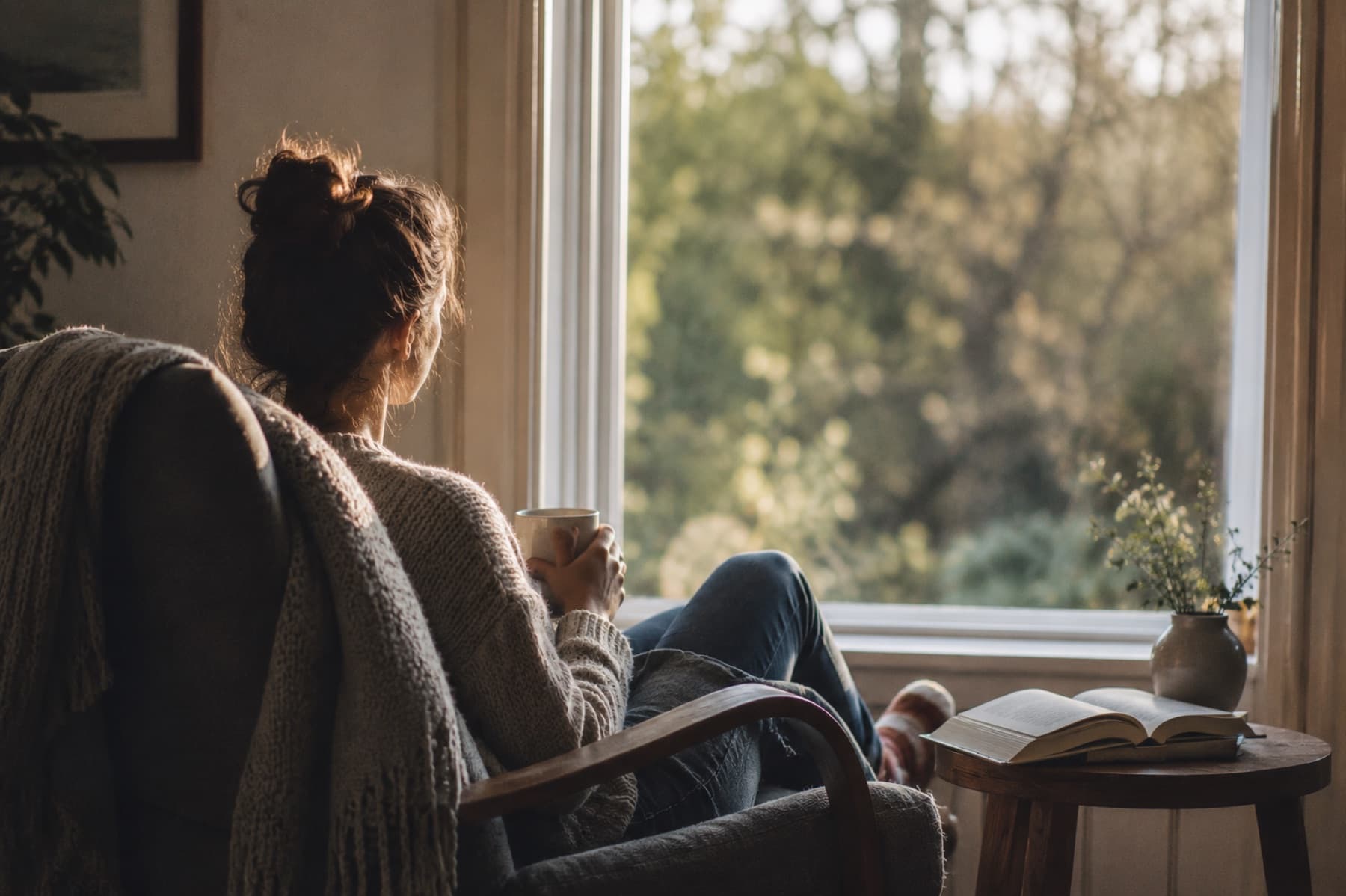 A woman taking a quiet moment to reflect at home